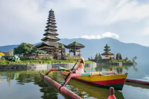 Voyageuse en barque près d’un temple balinais