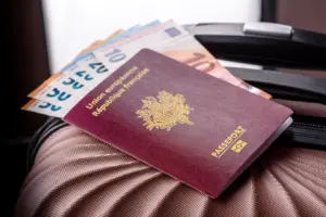 Passeport français et billets en euros sur une valise